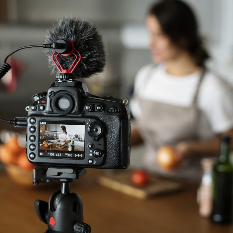 Female vlogger recording cooking related broadcast at home